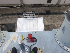 Intervention de Height Technician in Building pour l'installation d'une plateforme de départ d'échelle. Il s'agit là d'un moyen d'accès à la toiture d'un transformateur électrique. Intervention dans le cadre de travaux de sécurisation d'un transformateur contre les chutes de hauteur.