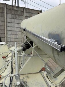 Intervention de Height Technician in Building pour la mise en place d'équipements de protection individuelle. Il s'agit là de mettre en place une ligne de vie horizontale rail, maintenue par trois supports Cupro. L'installation s'est faite sur le conservateur d'un transformateur. Ce sont là des dispositifs d'ancrage contre les chutes de hauteur.